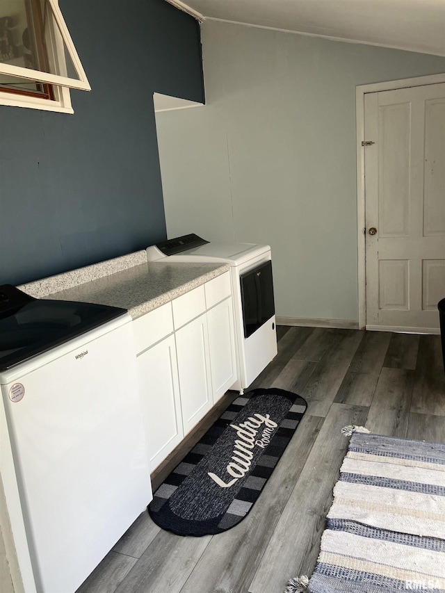 114 S State St, Annawan, IL 61234 - kitchen with stove, lofted ceiling, white cabinetry, dark wood-style floors, and light countertops