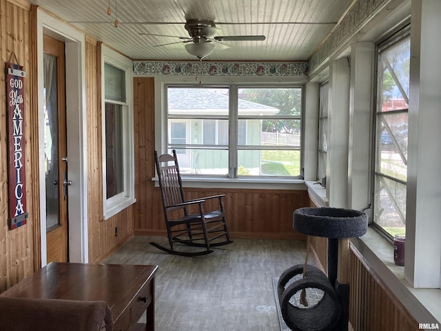 114 S State St, Annawan, IL 61234 - sunroom with a ceiling fan, wood finished floors, and wood walls