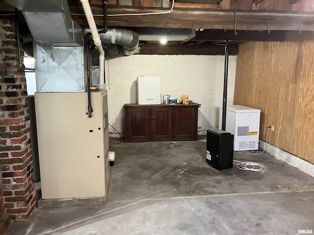 114 S State St, Annawan, IL 61234 - unfinished basement featuring refrigerator and heating unit