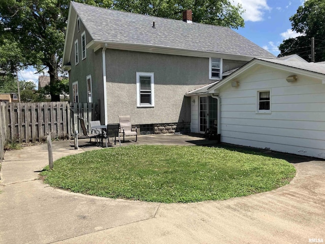 114 S State St, Annawan, IL 61234 - rear view of house with a patio area, roof with shingles, and stucco siding