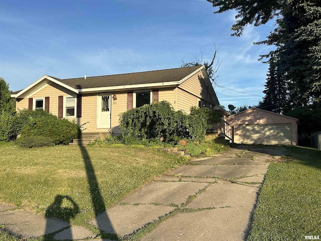 1501 24th Pl, Sterling, IL 61081 - ranch-style home with a front yard, a detached garage, and an outbuilding