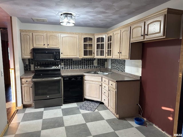 1501 24th Pl, Sterling, IL 61081 - kitchen featuring black appliances, light brown cabinets, light flooring, and tasteful backsplash
