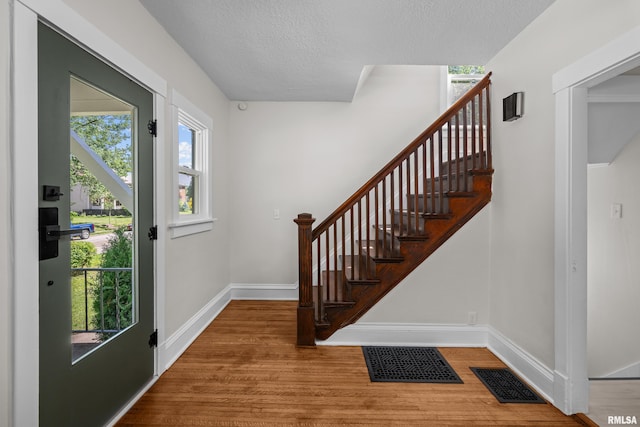 2664 Fair Ave, Davenport, IA 52803 - entryway featuring wood finished floors, stairs, and a textured ceiling