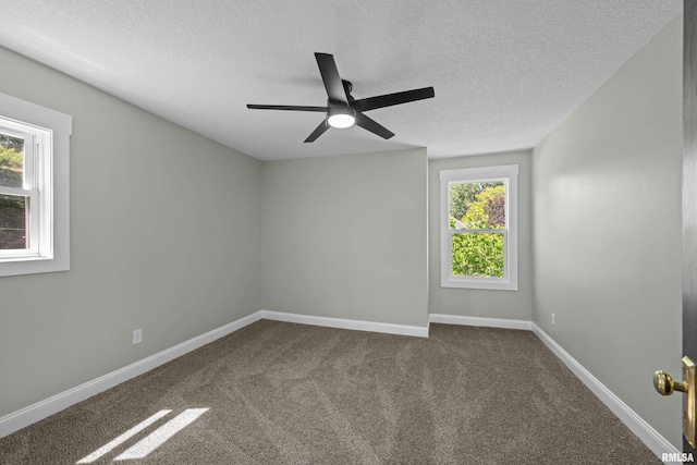 2664 Fair Ave, Davenport, IA 52803 - empty room featuring a textured ceiling, dark carpet, and ceiling fan