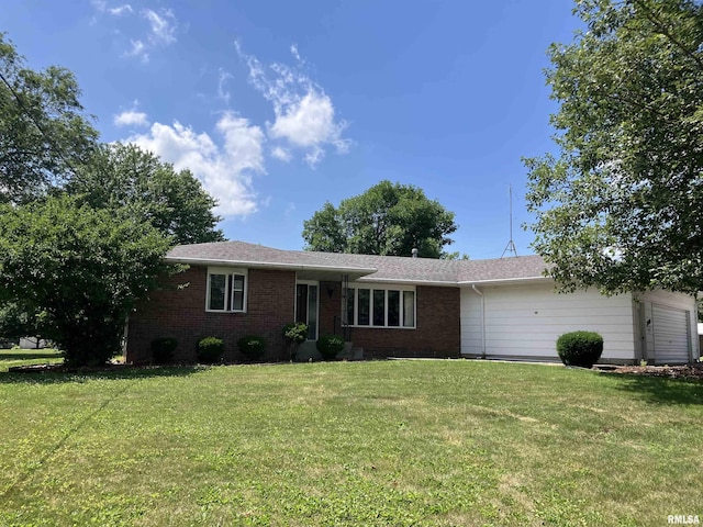 200 S Main St, Annawan, IL 61234 - ranch-style house featuring brick siding, a front lawn, a garage, and roof with shingles