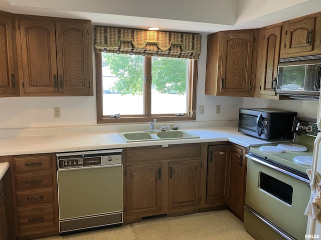 200 S Main St, Annawan, IL 61234 - kitchen with dishwashing machine, black microwave, white electric range oven, and light countertops