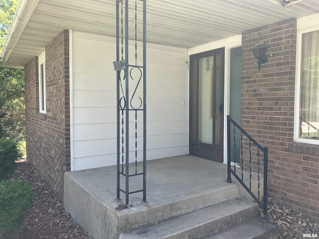 200 S Main St, Annawan, IL 61234 - doorway to property featuring brick siding and covered porch