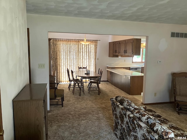 200 S Main St, Annawan, IL 61234 - kitchen with carpet flooring, light countertops, decorative light fixtures, and stainless steel dishwasher