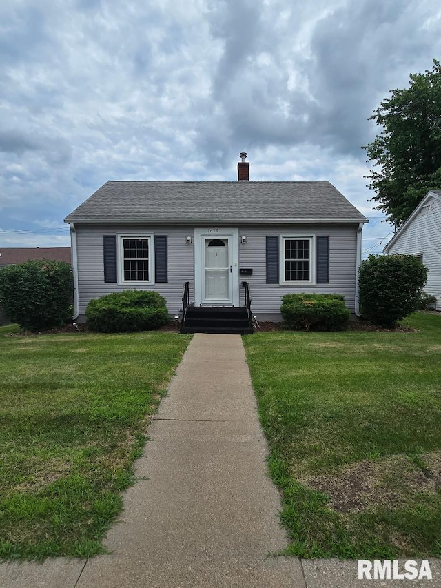 1619 Pershing Blvd, Clinton, IA 52732 - view of front of house with a chimney, a front lawn, and roof with shingles