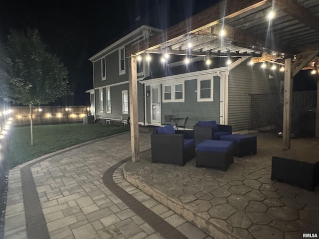 128 S 2nd St, Le Claire, IA 52753 - patio at night featuring a patio, an outdoor living space, and a fenced backyard