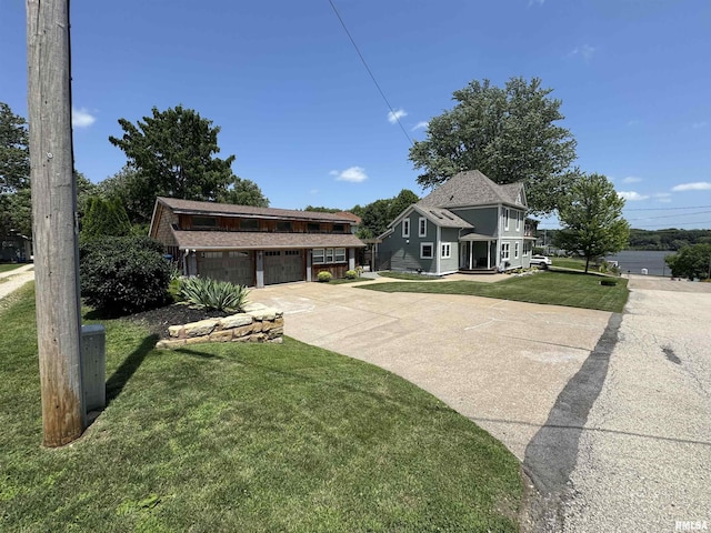 128 S 2nd St, Le Claire, IA 52753 - view of front of property featuring driveway, a front lawn, and a garage