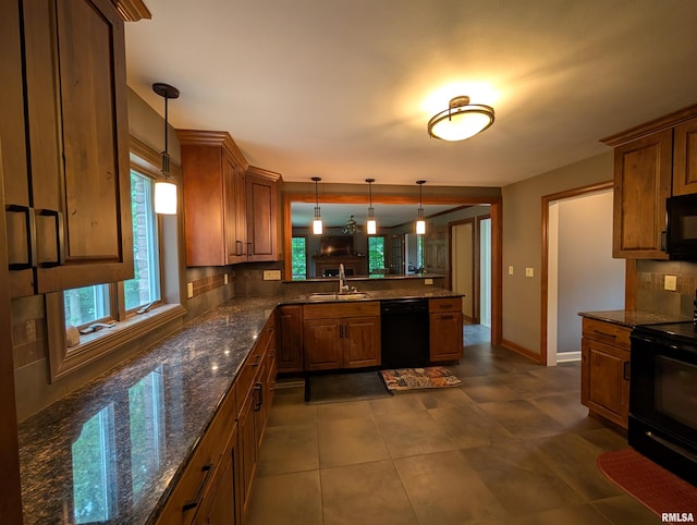 1315 W Wexford Pl, Peoria, IL 61615 - kitchen featuring black appliances, a peninsula, brown cabinets, and decorative backsplash