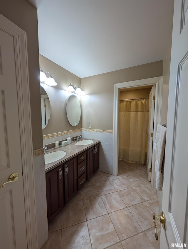 1315 W Wexford Pl, Peoria, IL 61615 - bathroom with double vanity, tile patterned floors, and tile walls