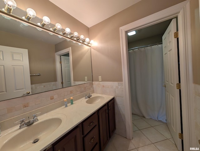 1315 W Wexford Pl, Peoria, IL 61615 - full bathroom with tile walls, double vanity, tile patterned flooring, wainscoting, and a shower with shower curtain