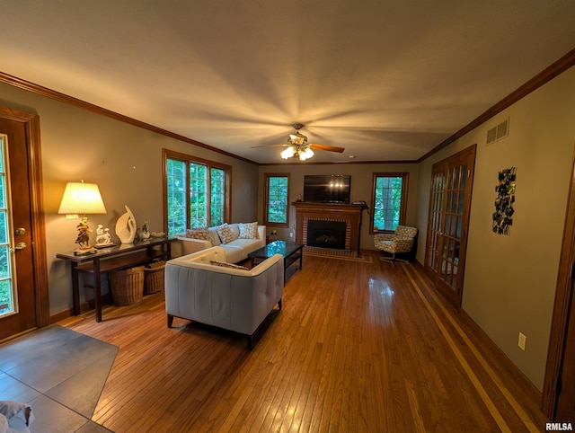 1315 W Wexford Pl, Peoria, IL 61615 - living area with wood-type flooring, a fireplace, a ceiling fan, and crown molding