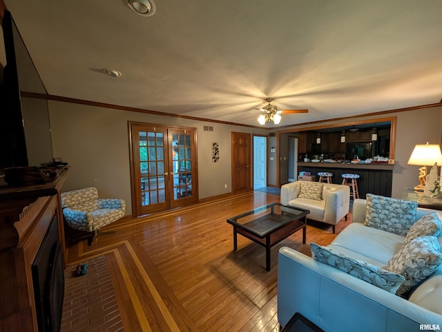 1315 W Wexford Pl, Peoria, IL 61615 - living room with french doors, crown molding, ceiling fan, and light wood finished floors