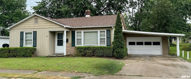 905 W Boulevard St, Marion, IL 62959 - ranch-style house with a front yard, a chimney, roof with shingles, concrete driveway, and an attached garage