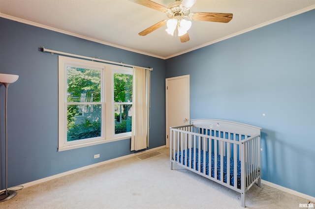 1506 E Oak St, West Frankfort, IL 62896 - unfurnished bedroom with carpet flooring, ornamental molding, a crib, and ceiling fan