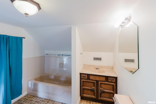 1506 E Oak St, West Frankfort, IL 62896 - bathroom with vaulted ceiling, a garden tub, vanity, and tile patterned floors