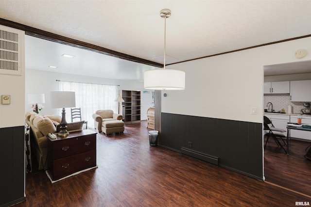 103 Westernaire Dr, Marion, IL 62959 - living room featuring baseboard heating, dark wood-style flooring, a wainscoted wall, and ornamental molding