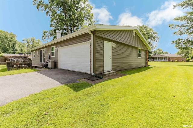 103 Westernaire Dr, Marion, IL 62959 - view of home's exterior with a chimney, driveway, a garage, and a yard