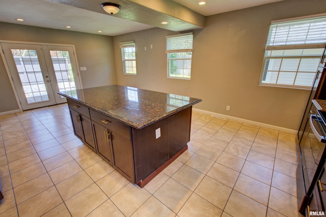 1008 5th Ave, Camanche, IA 52730 - kitchen featuring recessed lighting, french doors, range, light tile patterned floors, and a center island