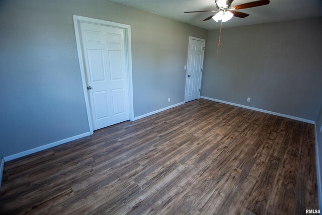 1008 5th Ave, Camanche, IA 52730 - unfurnished bedroom with dark wood finished floors and ceiling fan