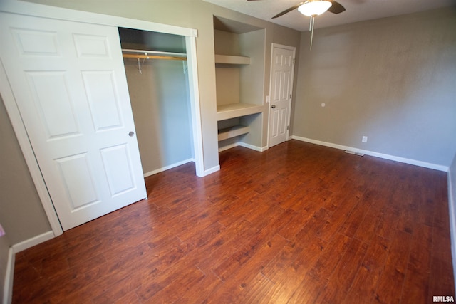 1008 5th Ave, Camanche, IA 52730 - unfurnished bedroom featuring dark wood finished floors, a closet, and ceiling fan