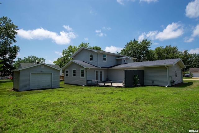 1008 5th Ave, Camanche, IA 52730 - rear view of house with a garage, an outbuilding, and a lawn