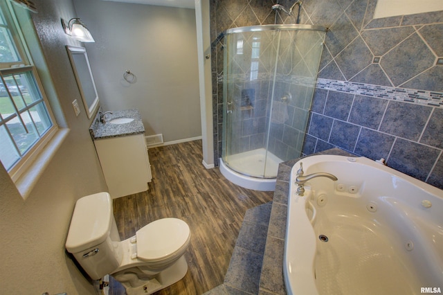 1008 5th Ave, Camanche, IA 52730 - bathroom featuring a stall shower, a whirlpool tub, vanity, and wood finished floors