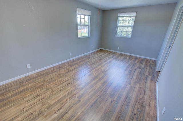 1008 5th Ave, Camanche, IA 52730 - spare room featuring wood finished floors and baseboards