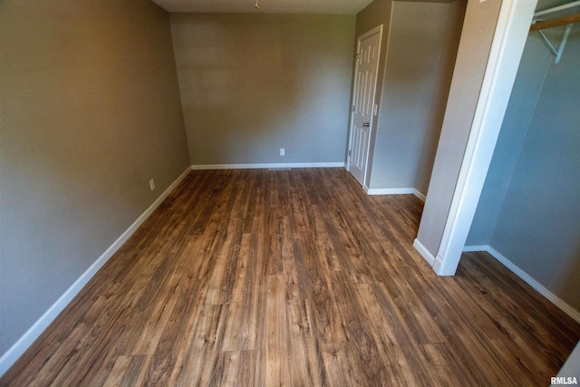 1008 5th Ave, Camanche, IA 52730 - empty room featuring dark wood-style floors and baseboards