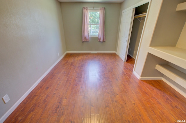 1008 5th Ave, Camanche, IA 52730 - unfurnished bedroom featuring hardwood / wood-style flooring and a closet