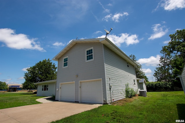 1008 5th Ave, Camanche, IA 52730 - view of side of home featuring an attached garage, a yard, and driveway