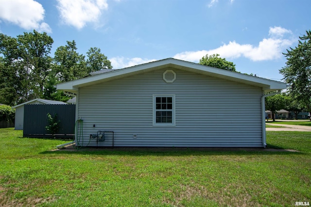 1008 5th Ave, Camanche, IA 52730 - view of home's exterior featuring a lawn and a shed