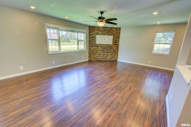1008 5th Ave, Camanche, IA 52730 - unfurnished living room featuring healthy amount of natural light, ceiling fan, dark wood-style flooring, and recessed lighting