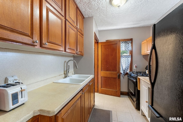 240 15th Ave, East Moline, IL 61244 - kitchen with black appliances, light countertops, brown cabinets, and light tile patterned floors