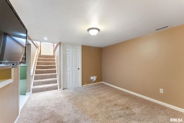 240 15th Ave, East Moline, IL 61244 - finished basement featuring a textured ceiling, carpet flooring, and stairway