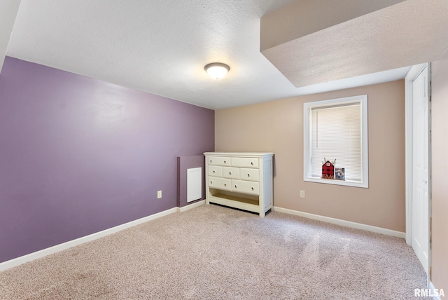 240 15th Ave, East Moline, IL 61244 - unfurnished bedroom featuring carpet and a textured ceiling