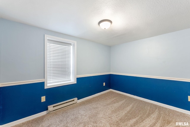 240 15th Ave, East Moline, IL 61244 - empty room featuring a baseboard radiator, carpet flooring, and a textured ceiling