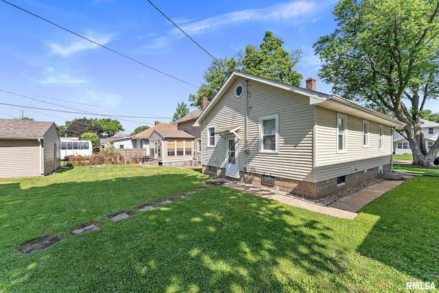 240 15th Ave, East Moline, IL 61244 - rear view of property with a chimney, entry steps, and a yard