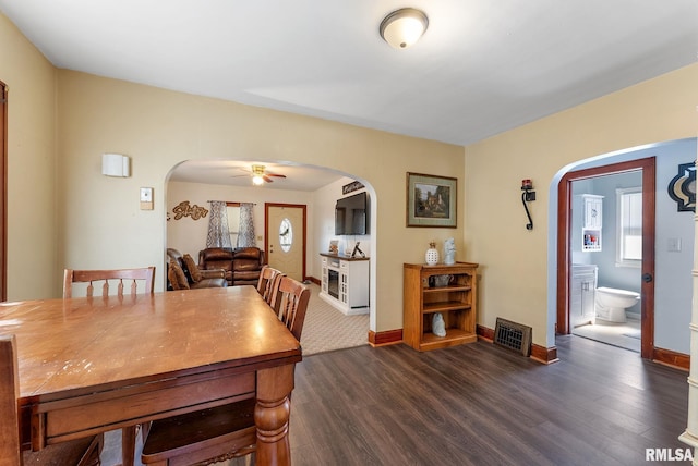 240 15th Ave, East Moline, IL 61244 - dining area with arched walkways, dark wood-type flooring, and a ceiling fan