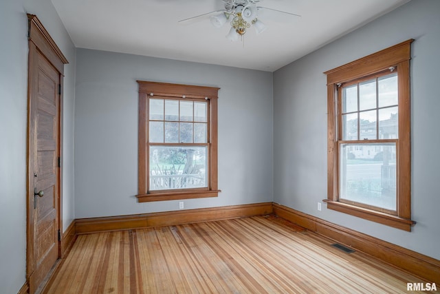 1035 W Locust St, Davenport, IA 52804 - spare room featuring plenty of natural light, hardwood / wood-style floors, and ceiling fan