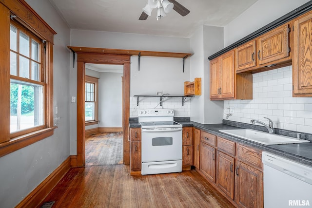 1035 W Locust St, Davenport, IA 52804 - kitchen with white appliances, dark wood-style floors, dark countertops, and decorative backsplash