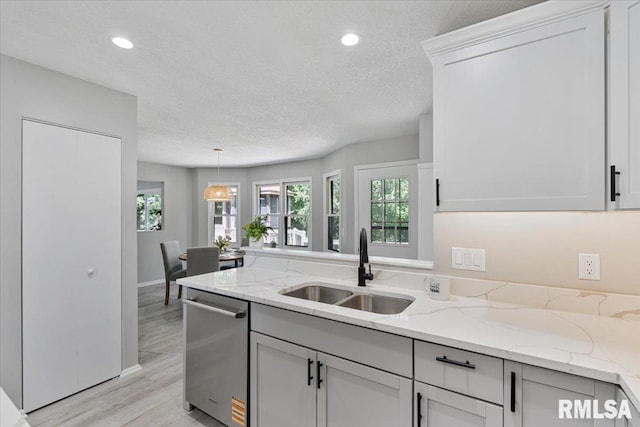 4050 4th St Unit B, East Moline, IL 61244 - kitchen featuring stainless steel dishwasher, light wood-type flooring, a textured ceiling, light stone countertops, and recessed lighting