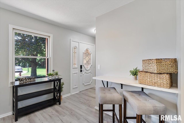 4050 4th St Unit B, East Moline, IL 61244 - dining space with light wood-style floors and a textured ceiling