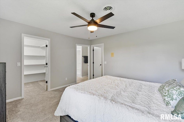 4050 4th St Unit B, East Moline, IL 61244 - bedroom with light colored carpet, a walk in closet, a ceiling fan, a closet, and connected bathroom