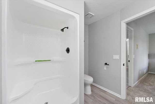 4050 4th St Unit B, East Moline, IL 61244 - full bathroom with a shower, wood finished floors, and a textured ceiling
