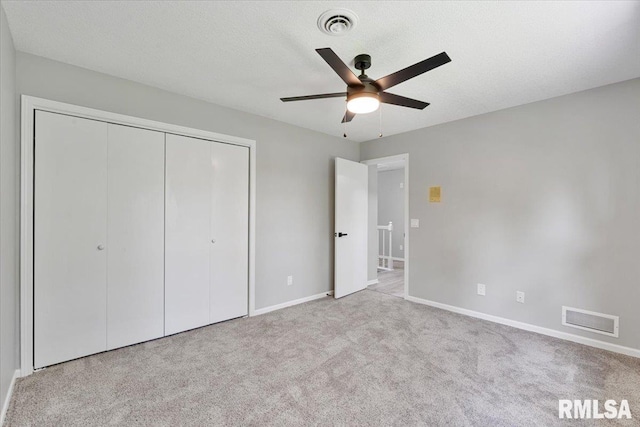 4050 4th St Unit B, East Moline, IL 61244 - unfurnished bedroom featuring carpet flooring, a closet, and a ceiling fan