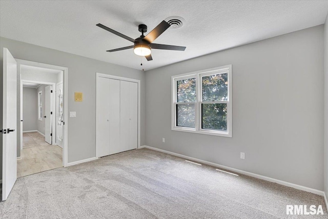 4050 4th St Unit B, East Moline, IL 61244 - unfurnished bedroom with carpet, a closet, and a ceiling fan